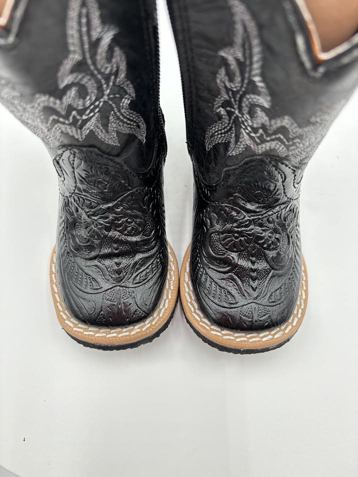 Black cowboy boots with intricate designs on a white background