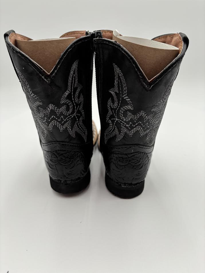 Black cowboy boots with intricate designs on a white background