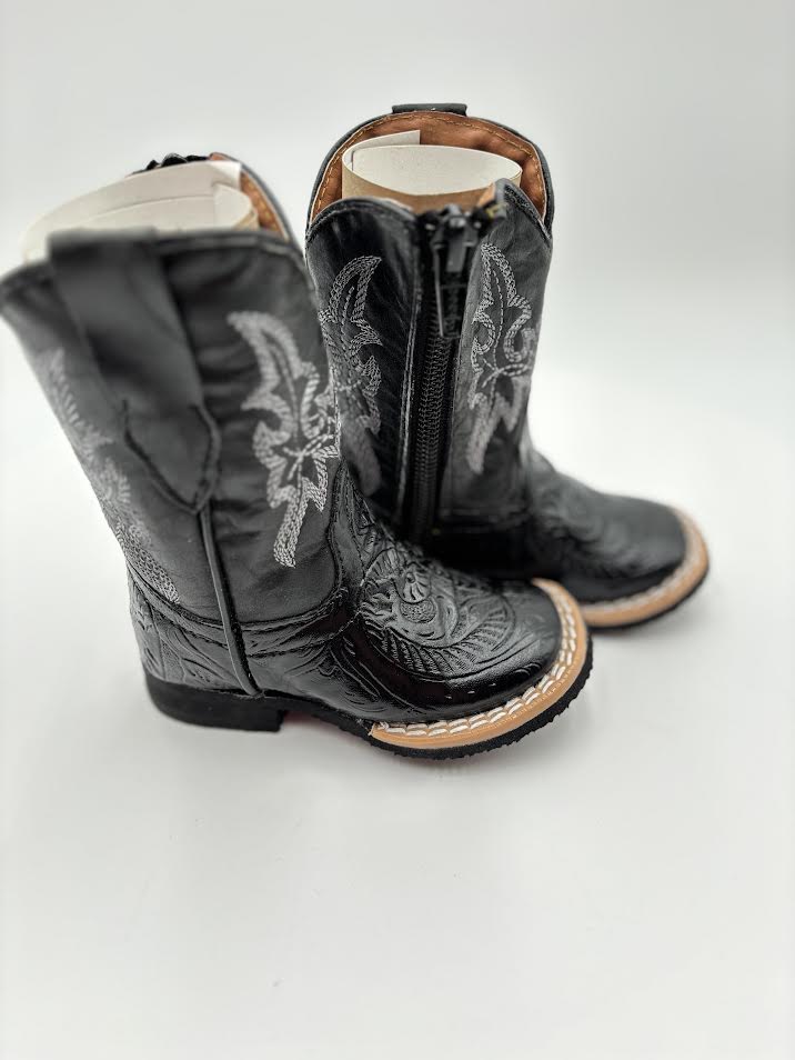 Pair of black cowboy boots with intricate designs on a white background