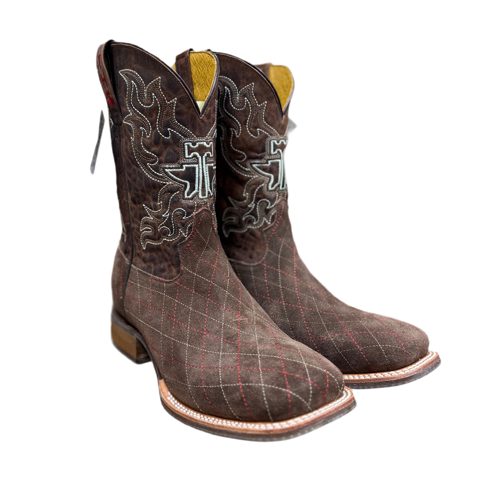 Pair of brown cowboy boots with intricate designs