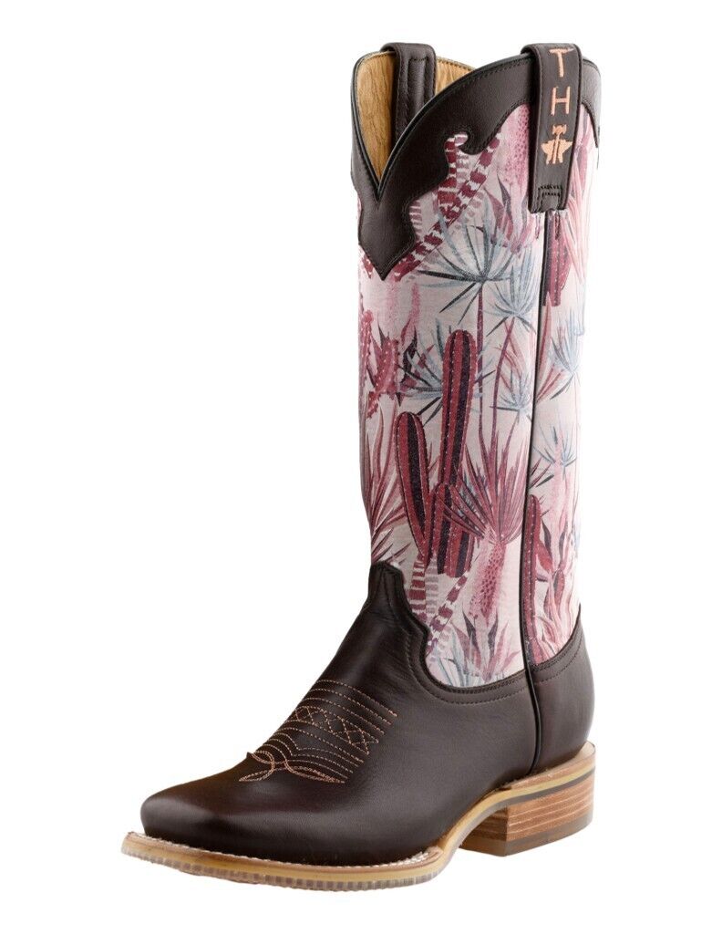 A pink and brown cactus-patterned boot with a metallic buckle and a cactus on the sole.