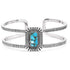 A silver-colored metal bracelet with a rectangular turquoise stone in the center