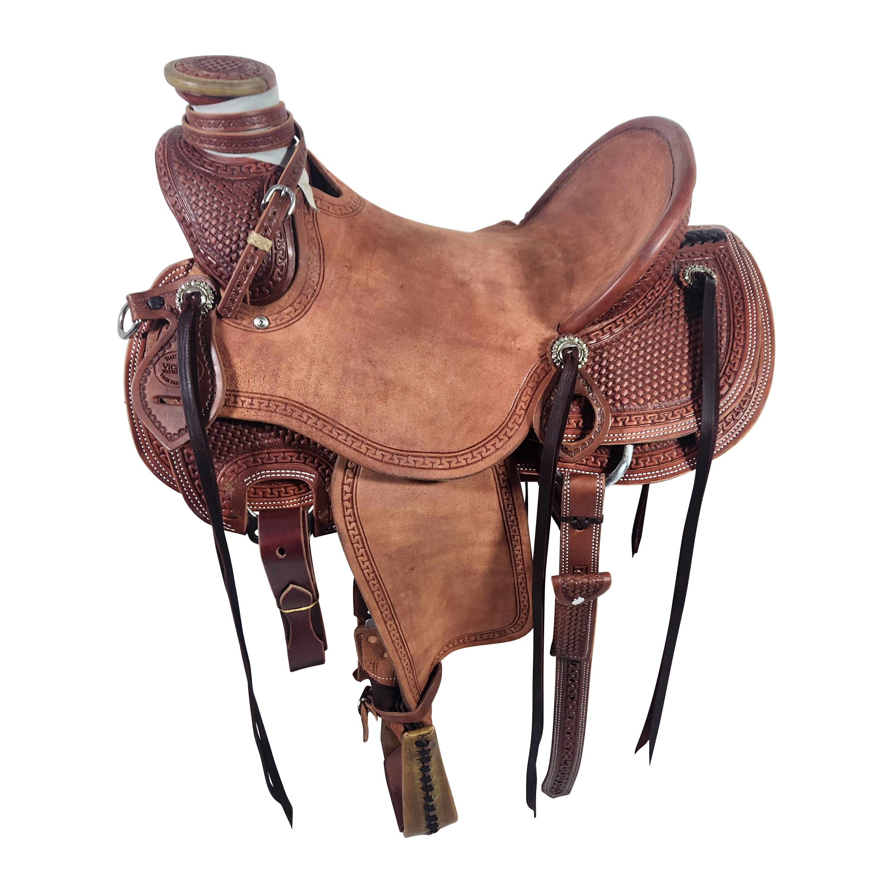A Vickers Elite VE11 saddle with a rough out leather finish, featuring a rigging plate, and stirrups