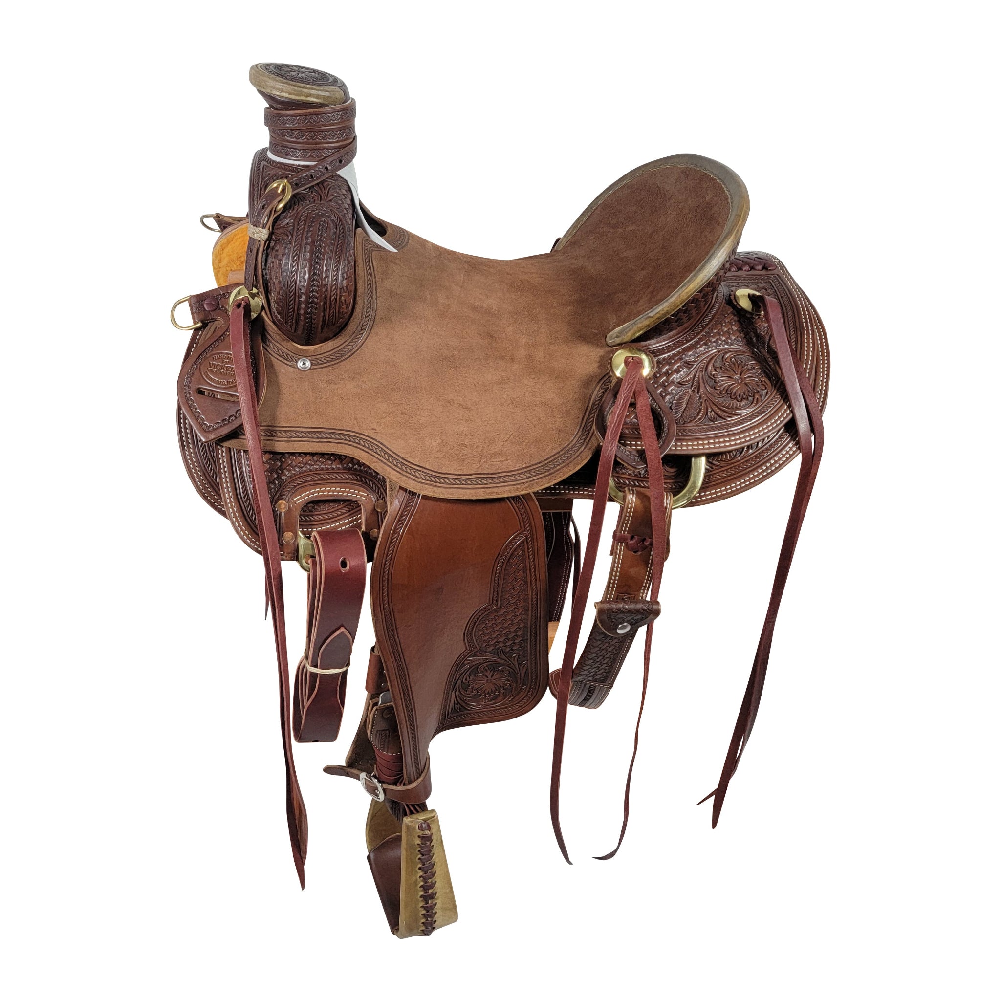 A brown Vickers Elite saddle with tooling and a walnut leather finish, equipped with rigging, breast collar D's, a bull hide tree, and accessories such as a hoof pick holder and strings.