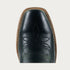 Black leather boot with intricate brown stitching on a light gray background