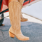 Beige cowboy boots with white embroidery