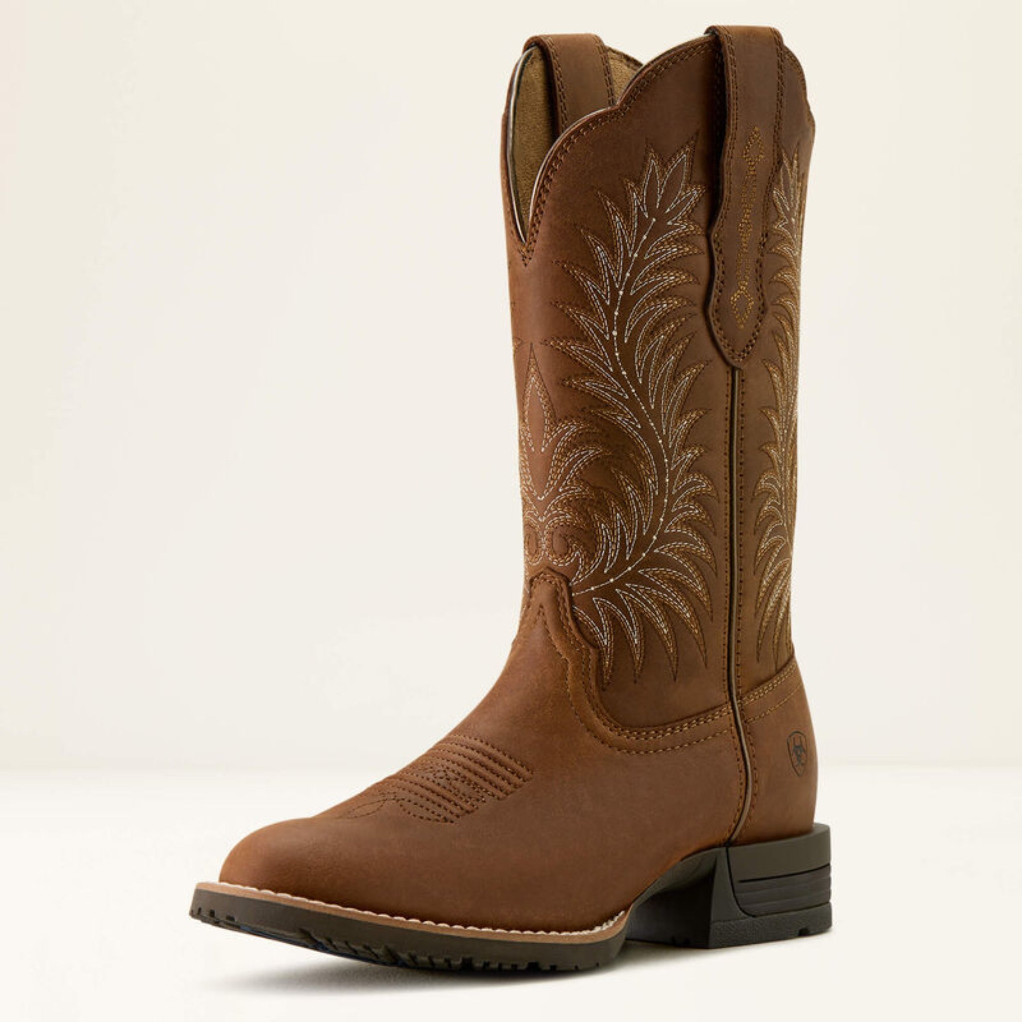 Brown cowboy boot with intricate embroidery on a white background