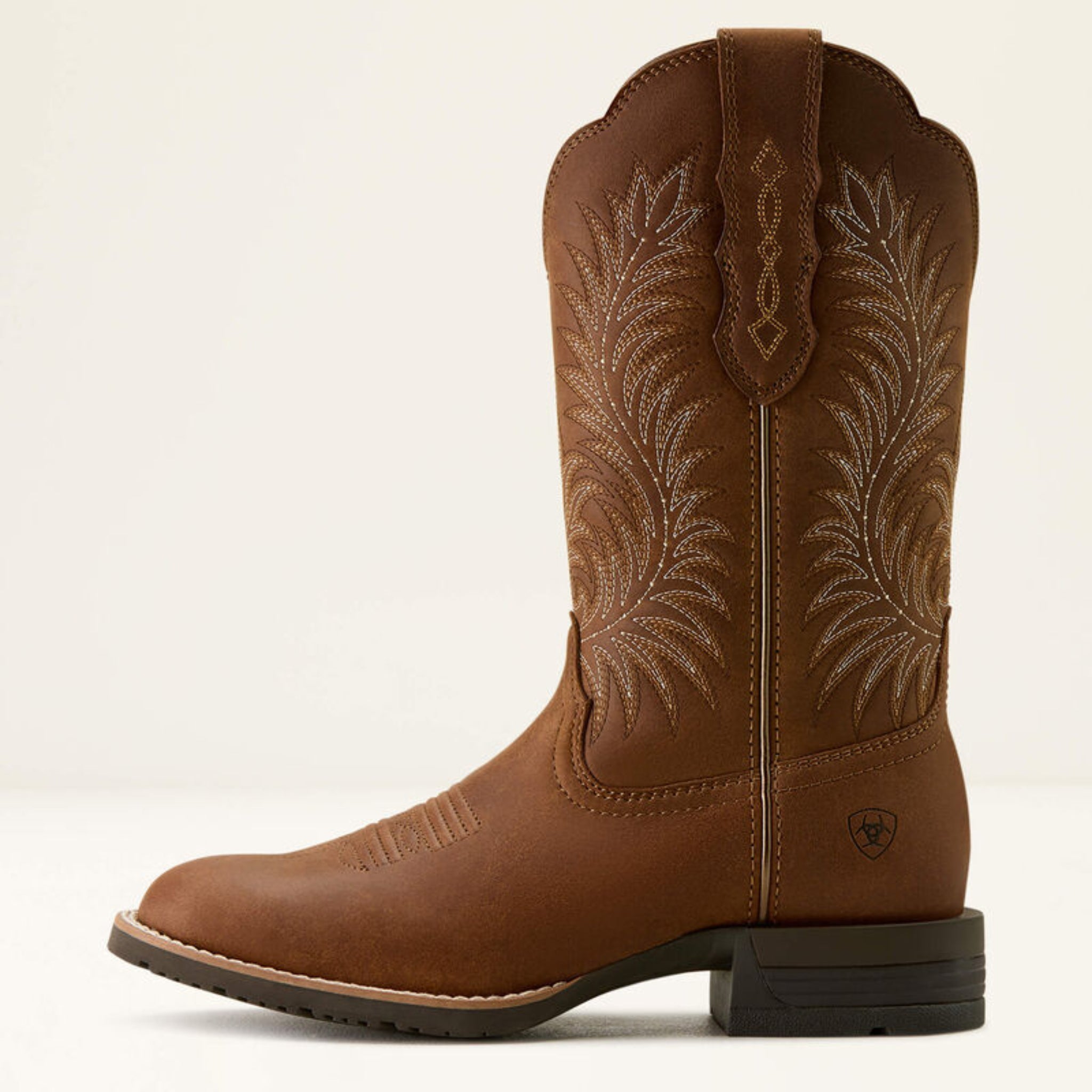 Brown cowboy boot with intricate embroidery on a white background