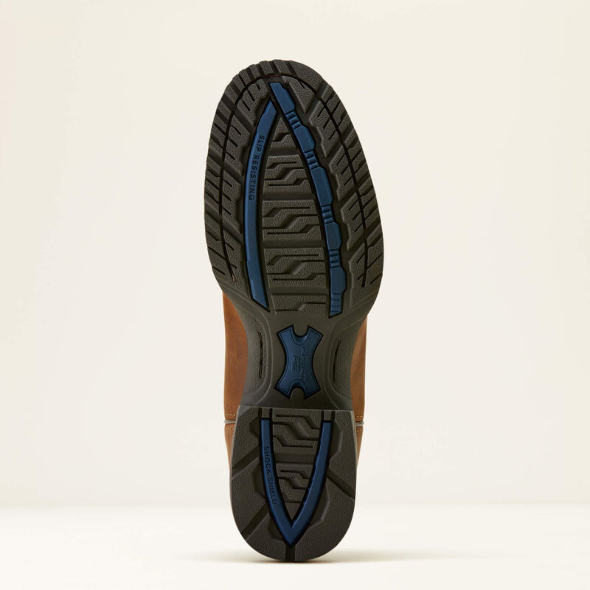 Close-up of a shoe sole with blue rubber accents on a beige background