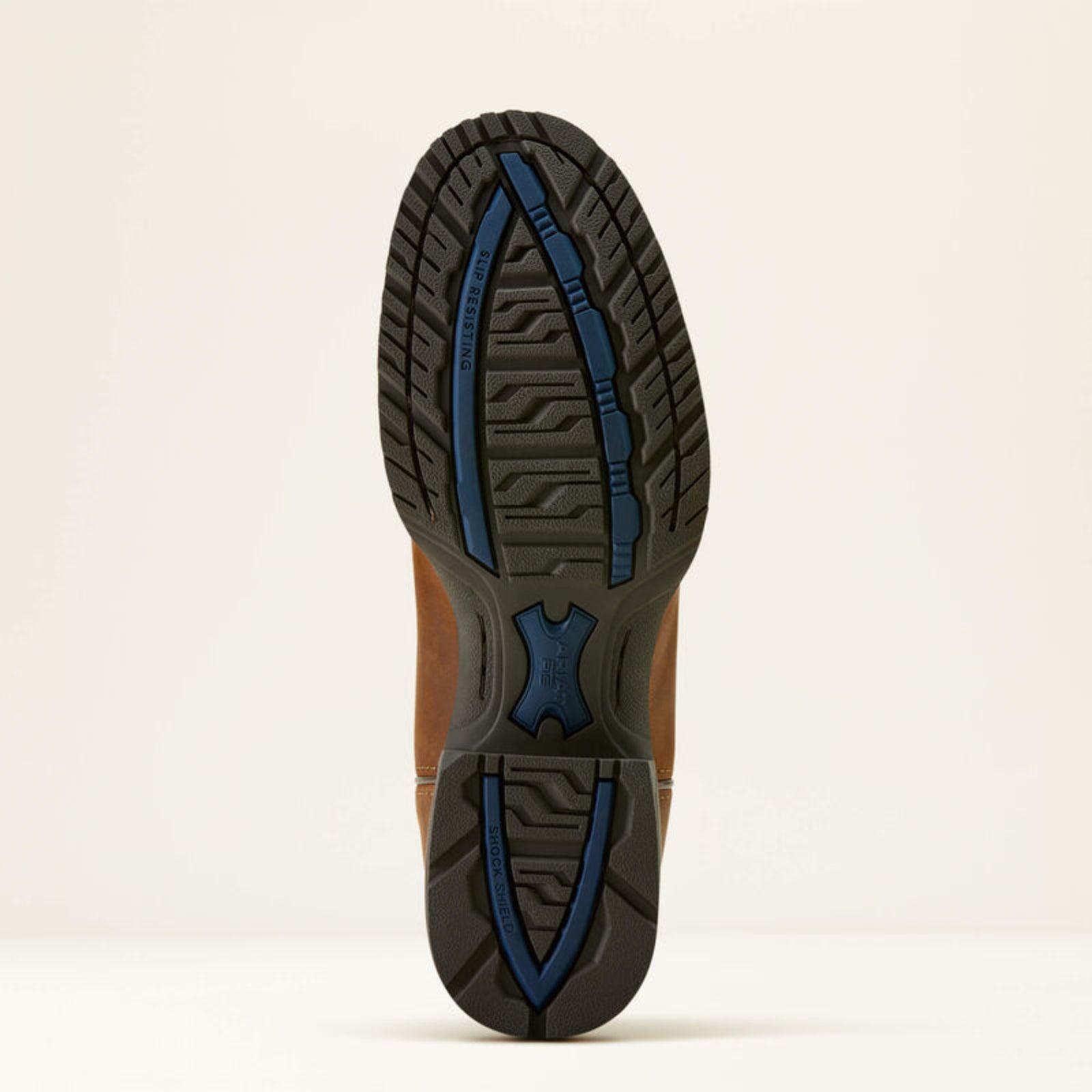 Close-up of a shoe sole with blue rubber accents on a beige background