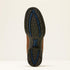 Close-up of a shoe sole with blue rubber accents on a beige background