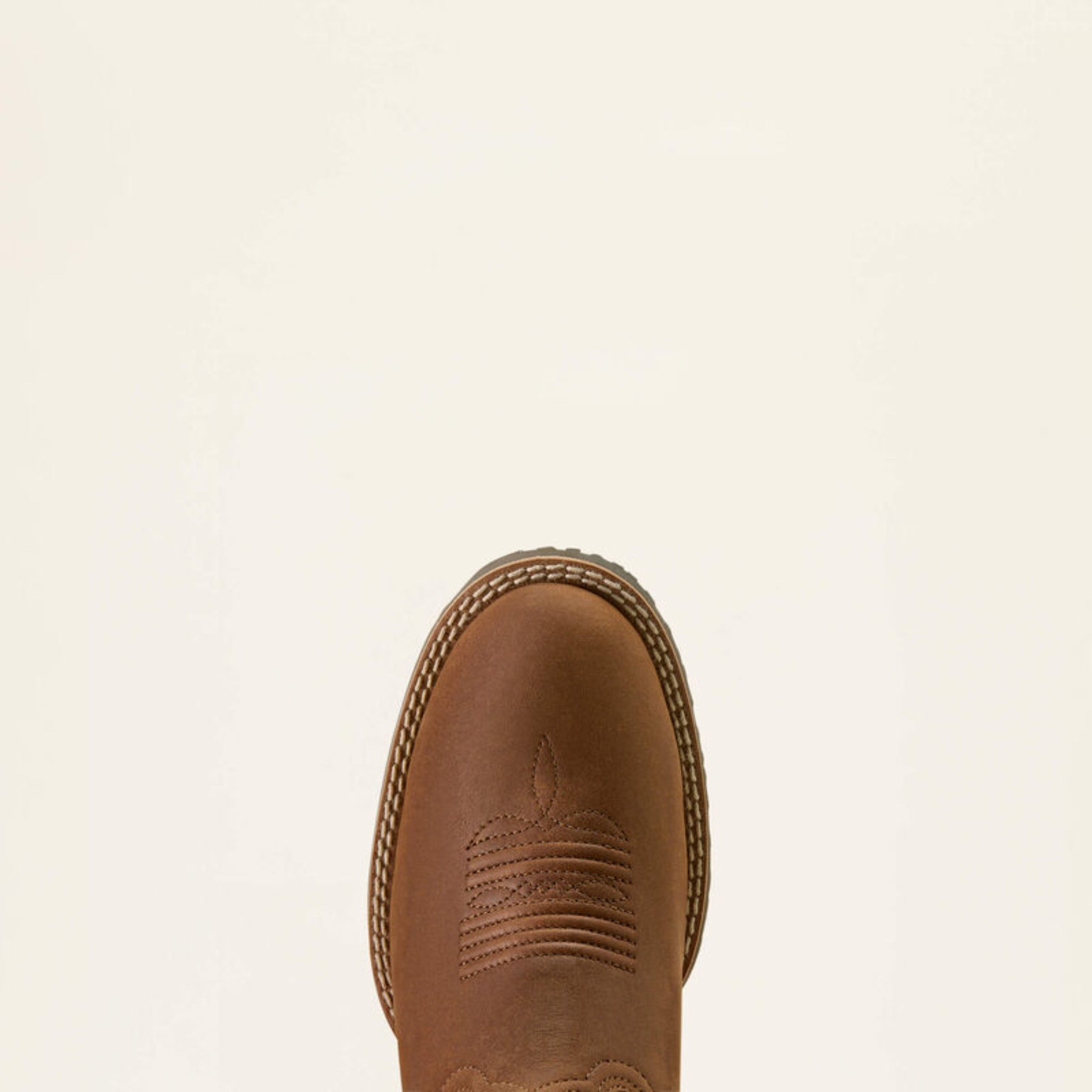 Brown leather boot on a beige background