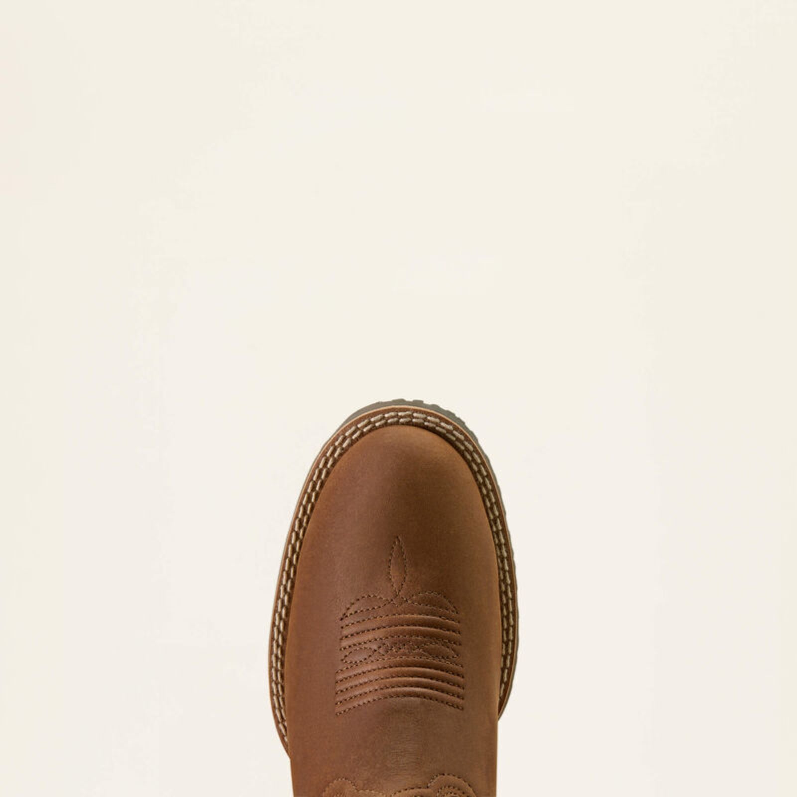 Brown leather boot on a beige background