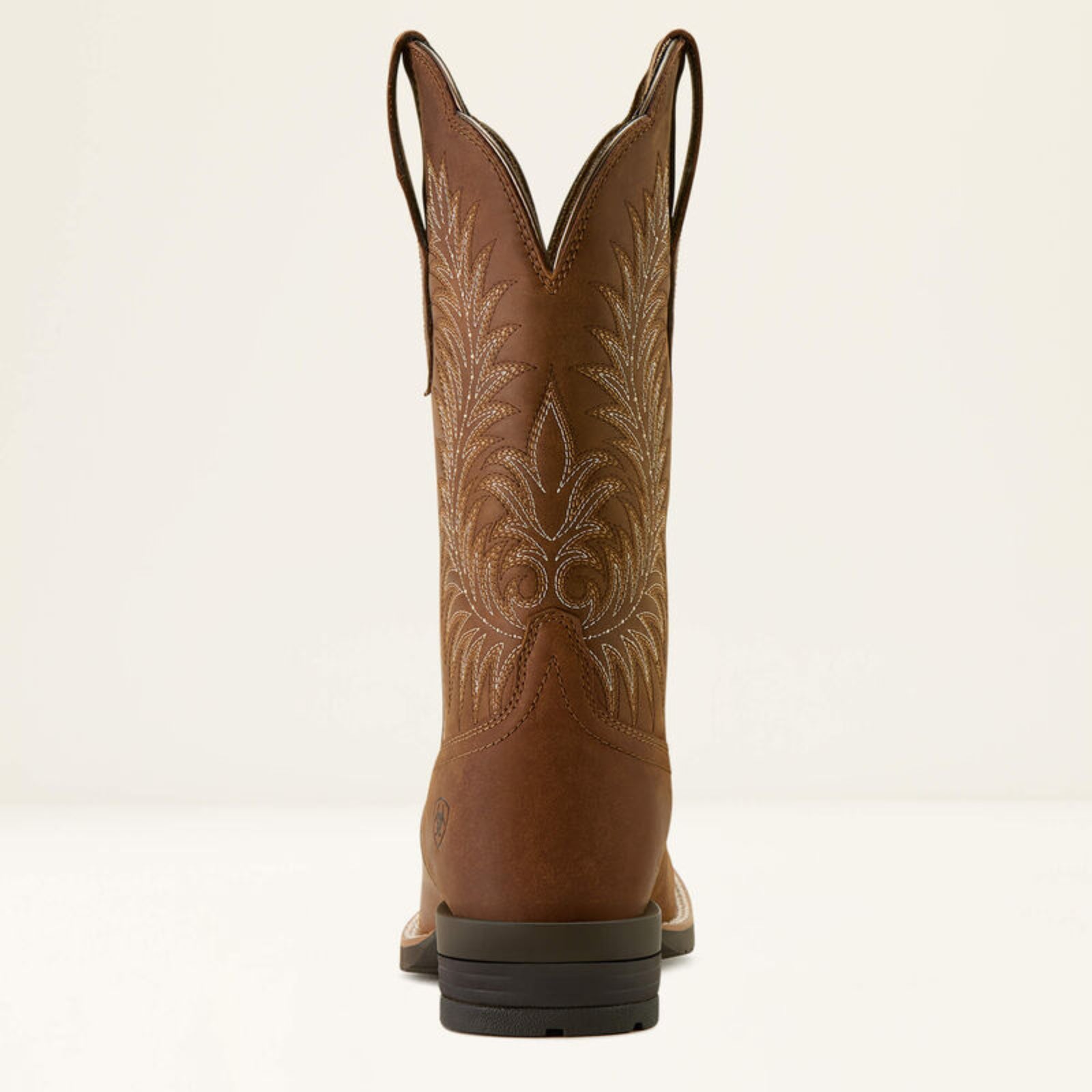 Brown cowboy boot with intricate embroidery on a white background