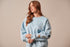 Ladies light blue sweatshirt with the Kimes brand logo and appliqued patches on left sleeve