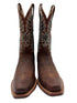 Pair of brown cowboy boots with intricate patterns on a white background