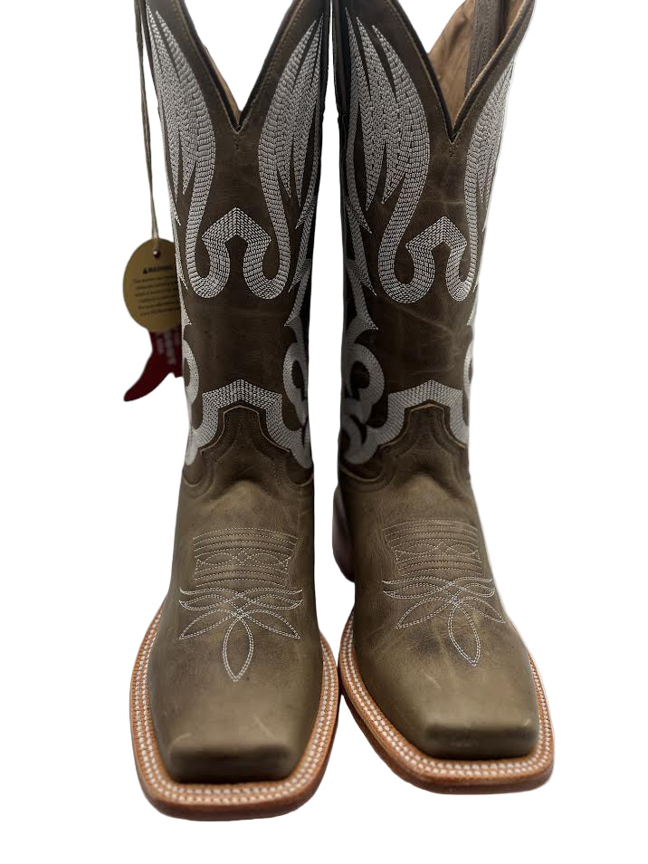 Pair of green cowboy boots with white embroidery on a white background