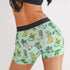 Shorts with cowboy boot and hat pattern on a green background
