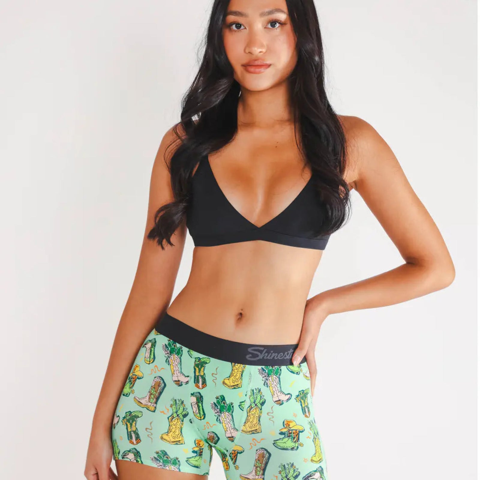 Woman wearing a black bra and patterned underwear 