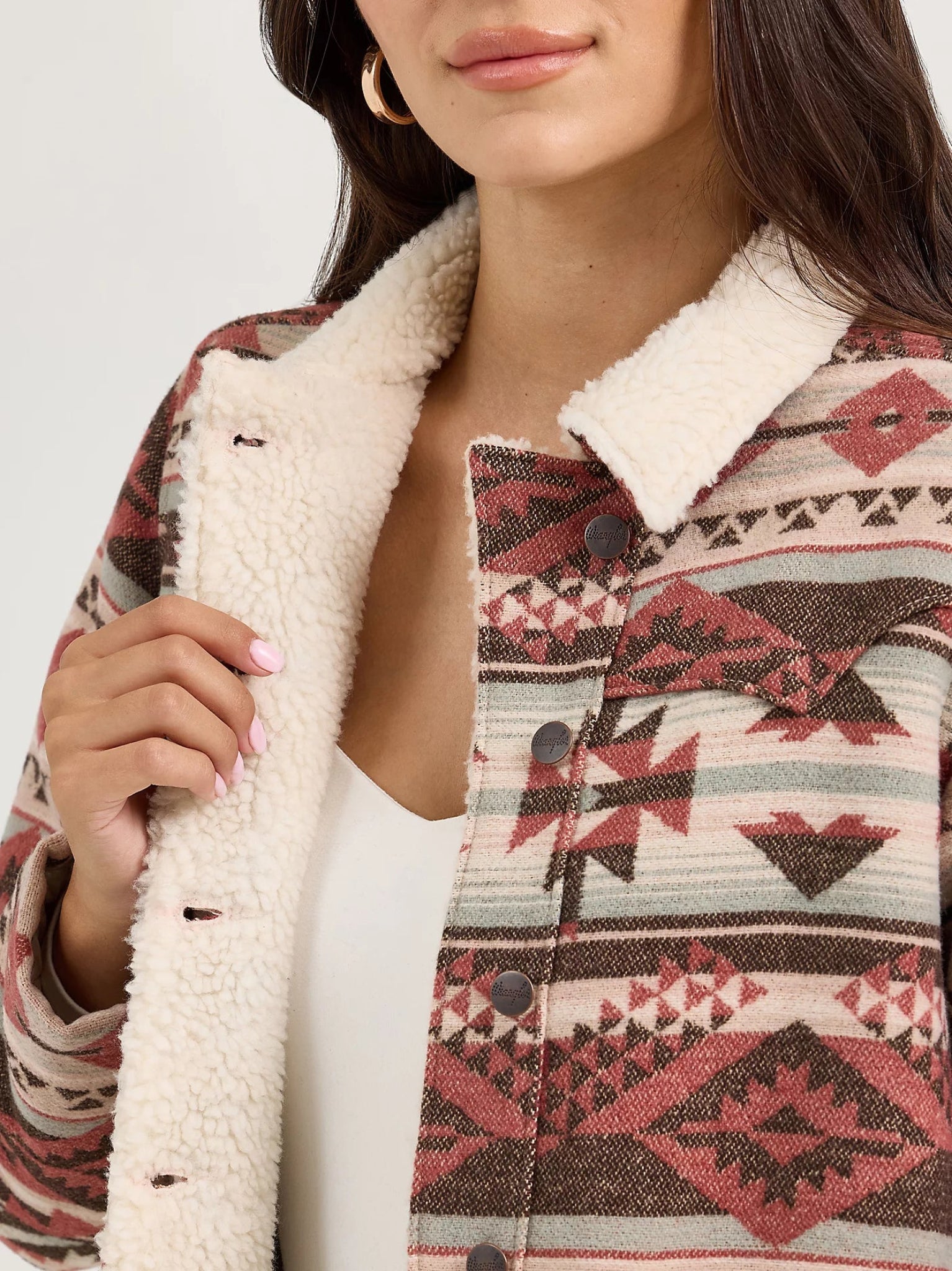 Person wearing a patterned jacket with a white Sherpa lining