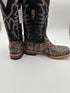 Pair of cowboy boots with a patterned sole on a white background
